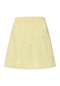 Jupe jaune avec taille élastique et motifs floraux brodés ajourés.
