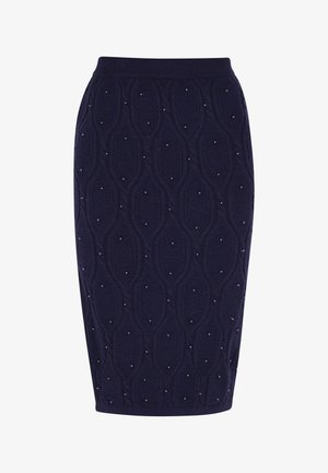 Strikket blyantskørt i mørk navy, med en tekstureret diamantmønster og små perlelignende accenter hele vejen igennem. Elastisk talje for bedre pasform.