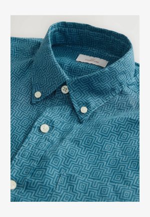Turquoise patterned shirt with a geometric design, featuring a button-down collar and white buttons, made from a textured fabric.