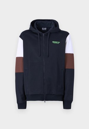 Zip-up hoodie in navy with white and brown accent stripes. Features a soft texture, kangaroo pockets, and a green logo on the chest.