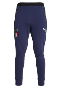 Marineblauwe joggers met zwarte zijaccenten, een elastische tailleband en aansluitende boorden. Voorzien van een gouden logo en een kleurrijke Italia-badge op de heup.