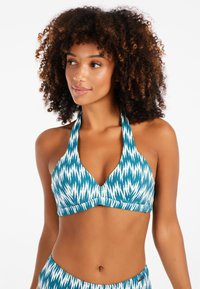 Teal bikinin yläosa, jossa on geometristen valkoisten kuvioiden painatus, nyörikiinnitys ja V-muotoinen kaula-aukko. Rakenteellinen kangas, jossa on sileä pinta.