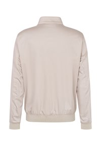 Helle beige Bomberjacke mit Stehkragen, elastischen Bündchen und gerafftem Saum. Glattes, glänzendes Material ohne sichtbare Beschläge oder Taschen.