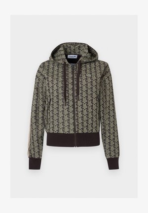 Giacca con cappuccio e zip con motivo geometrico beige e verde scuro, polsini e orlo a coste, righe laterali e logo Lacoste sul petto.
