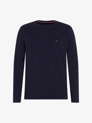 Navy long-sleeve t-shirt made of soft cotton. Features a crew neckline and a small logo on the left chest with contrasting red and white accents.