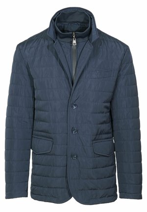 Giacca imbottita blu navy con colletto alto, chiusura a zip e tre bottoni. Presenta due tasche frontali e un tessuto liscio e testurizzato.