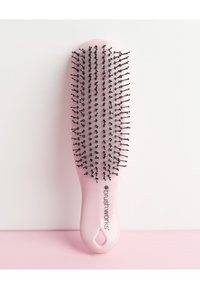 Detangling hairbrush with a soft pink plastic handle, flexible nylon bristles, and a smooth surface. Features a hole for hanging.