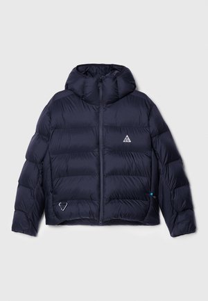 Navy puffer jacket with a hood, featuring a quilted design, zip closure, and a logo on the chest. Includes a side pocket with hardware detail.
