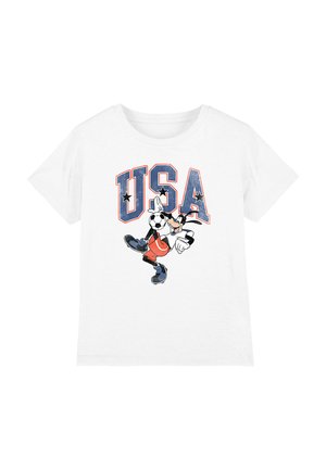 White short-sleeve t-shirt with "USA" in blue letters and a cartoon dog character kicking a soccer ball in front of the text.