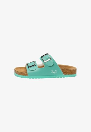Green slide sandal with two adjustable silver buckles, cork footbed, textured rubber outsole, and a smooth finish. Brand logo on side.