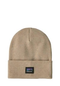 Gorro de punto beige con puño doblado y parche con el logo de Patagonia que presenta un diseño de montaña en colores azul, morado y negro.