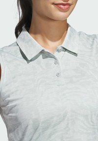 Light gray sleeveless polo shirt with a textured pattern, featuring a collar and three buttons on the placket. Smooth fabric.