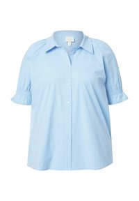 Camicia azzurra chiara con maniche corte a sbuffo e vestibilità ampia. Realizzata in un tessuto morbido con una superficie liscia e dettagli sul colletto.