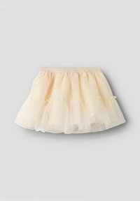 Tutu krilo v svetli bež barvi z večplastnimi naborki na robu. Elastični pas za prilagodljivo prileganje, z mehko teksturo in prozornim videzom.