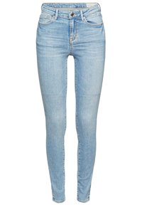 Jeans skinny azul claro hechos de denim, con un diseño clásico de cinco bolsillos, cierre de cremallera con botón y una textura ligeramente deslavada.