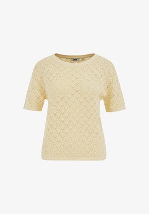 Rövid ujjú krémszínű kötött felső áttört rombuszmintával és kerek nyakkivágással, bordázott mandzsettákkal és szegéllyel.
