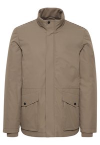 Felpa impermeabile beige con colletto alto, due tasche frontali e bottoni neri. Texture liscia con un design moderno e lineare.