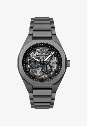 Reloj automático de Armani Exchange de metal cepillado con esfera esqueleto, tonos negro y plata, dos subesferas y una pulsera de metal eslabonada.