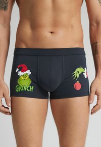 Boxers de marinero con gráficos del Grinch en verde, con un gorro de Santa y un adorno rojo. Hechos de una tela suave y elástica para mayor comodidad.