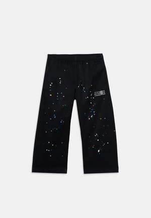 Black wide-leg pants with elastic waistband and multicolored paint splatter design, featuring a small white numeric print on the upper right leg.