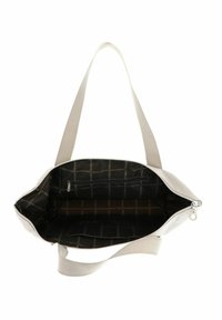 Sac fourre-tout beige avec un extérieur texturé, fermeture zippée sur le haut et poche intérieure. Doublé d'un motif noir arborant le logo de la marque. Deux poignées en tissu.