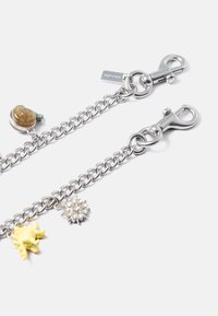 Silver chain featuring charms: a brown snail with green accents, a yellow creature, and a textured silver flower. Includes two clasps.