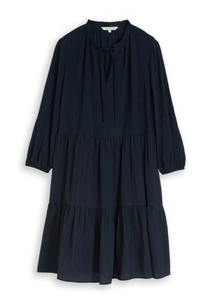Lange donkerblauwe jurk met laagjes, driekwart mouwen, geplooide halslijn met strikdetail en een gekreukte stoftextuur.