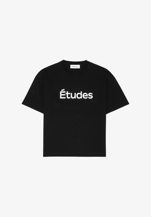 T-shirt noir à manches courtes en coton, avec le texte blanc "Études" sur le devant. Encolure ronde, coupe décontractée, texture douce.