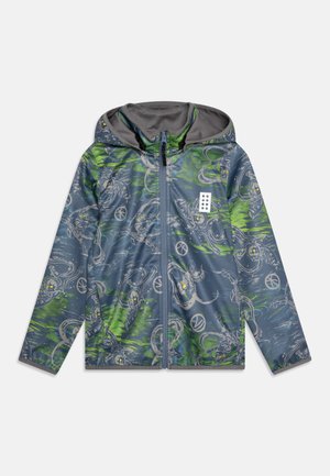 Hooded windbreaker jacket in blue with green accents. Features a graphic print, zip closure, and a soft interior lining.