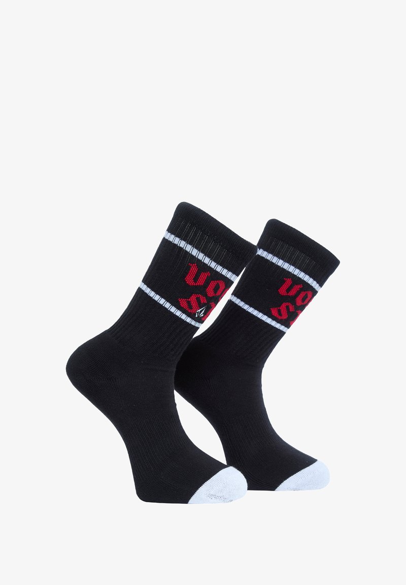Black socks with white toe accents and ribbed cuffs, featuring red text and white border detailing. Made of stretchy fabric for comfort.