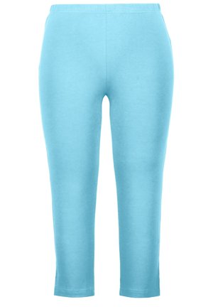 Jasnoniebieskie legginsy z elastycznym pasem, gładką teksturą i dopasowanym krojem, zwężającym się do długości 3/4, tuż nad kostką.