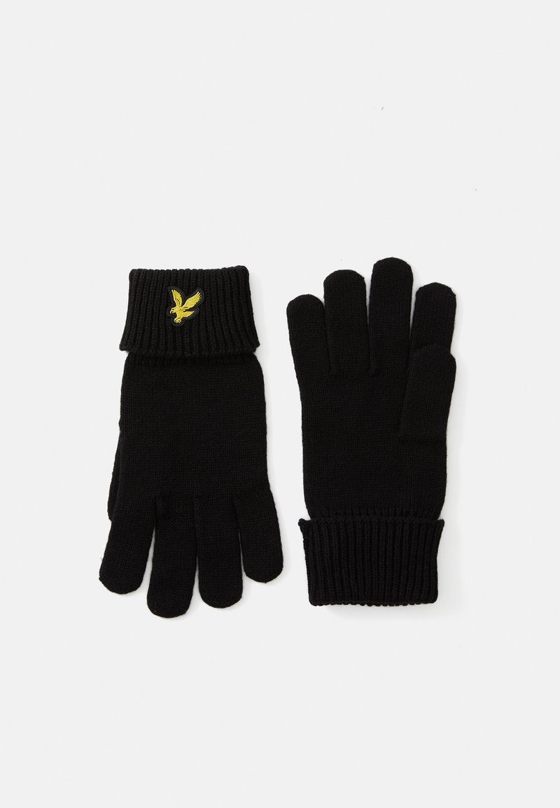 Sorte strikkede hansker med ribbestrikkede mansjetter, som har en liten gul brodert fuglelogo. Glatt tekstur og klassisk fem-finger design.