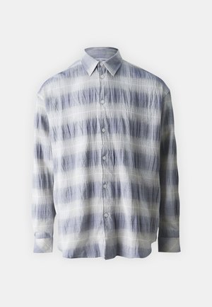 Button-up shirt made of textured fabric in blue and white with a striped pattern, featuring long sleeves and a classic collar.