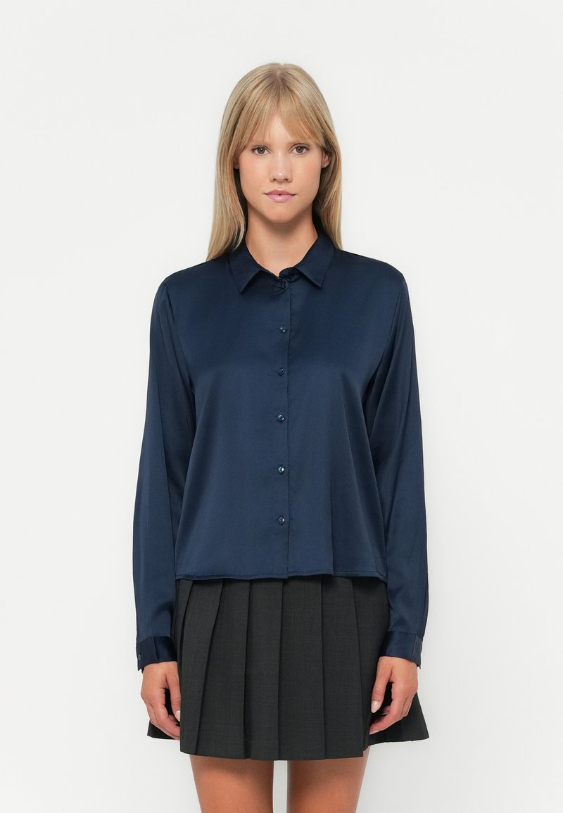 Navy blue satin button-up shirt with long sleeves and a rounded hem, featuring a classic collar and subtle sheen.