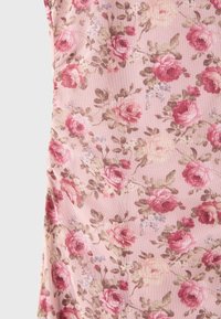 Pink fabric patterned with red and cream roses, green leaves, and small blue flowers, creating a soft, floral design.