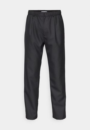 Black trousers made of smooth fabric, featuring an elastic waistband, front pleats, and straight legs. Simple design with no visible patterns.