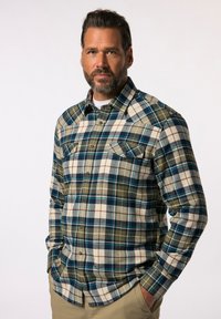 Geruite flanellen shirt in groen, blauw en crème met knoopzakken op de borst en lange mouwen. Textiel met een voelbare structuur en zichtbare naden.