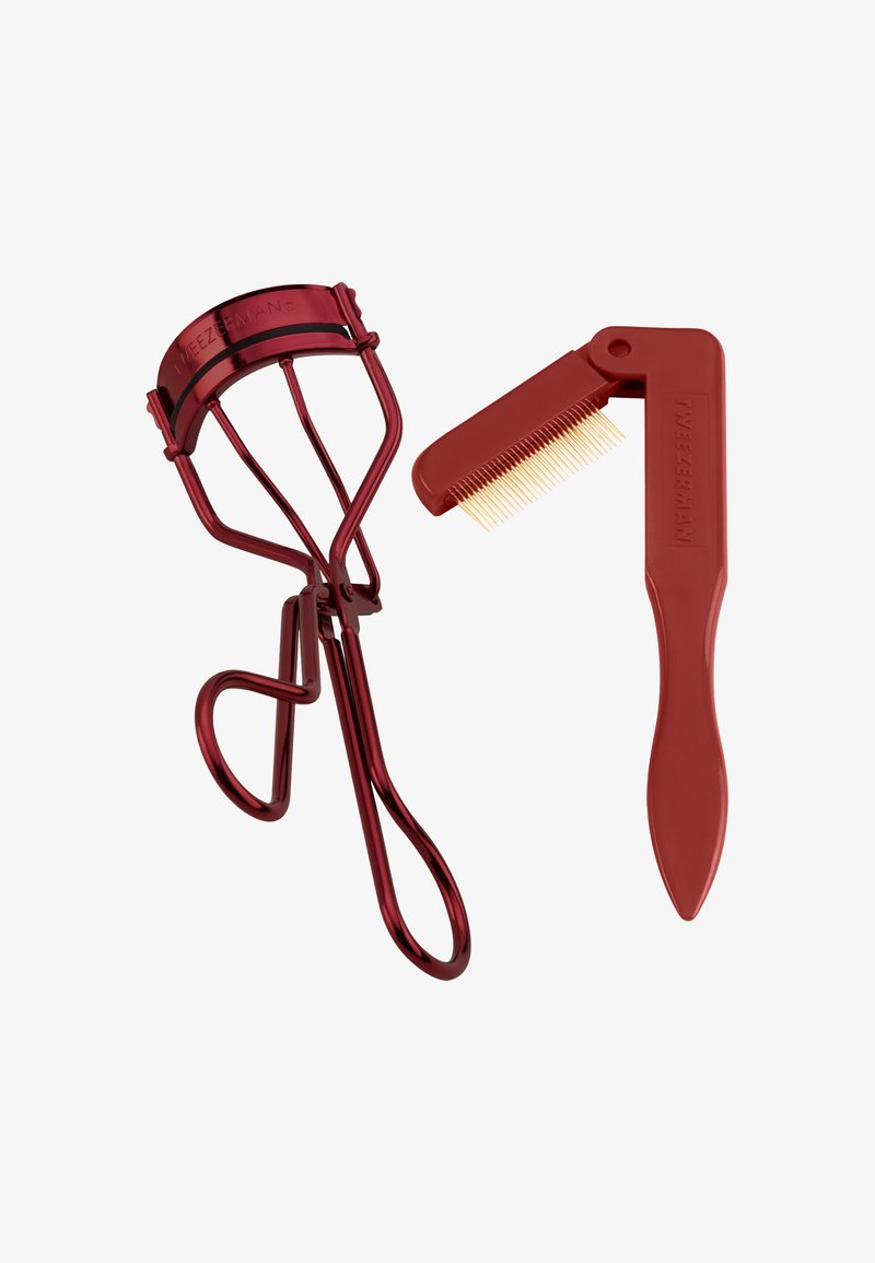 Piegaciglia in metallo rosso con tre punte, abbinato a un pettine rosso con denti sottili per la cura.