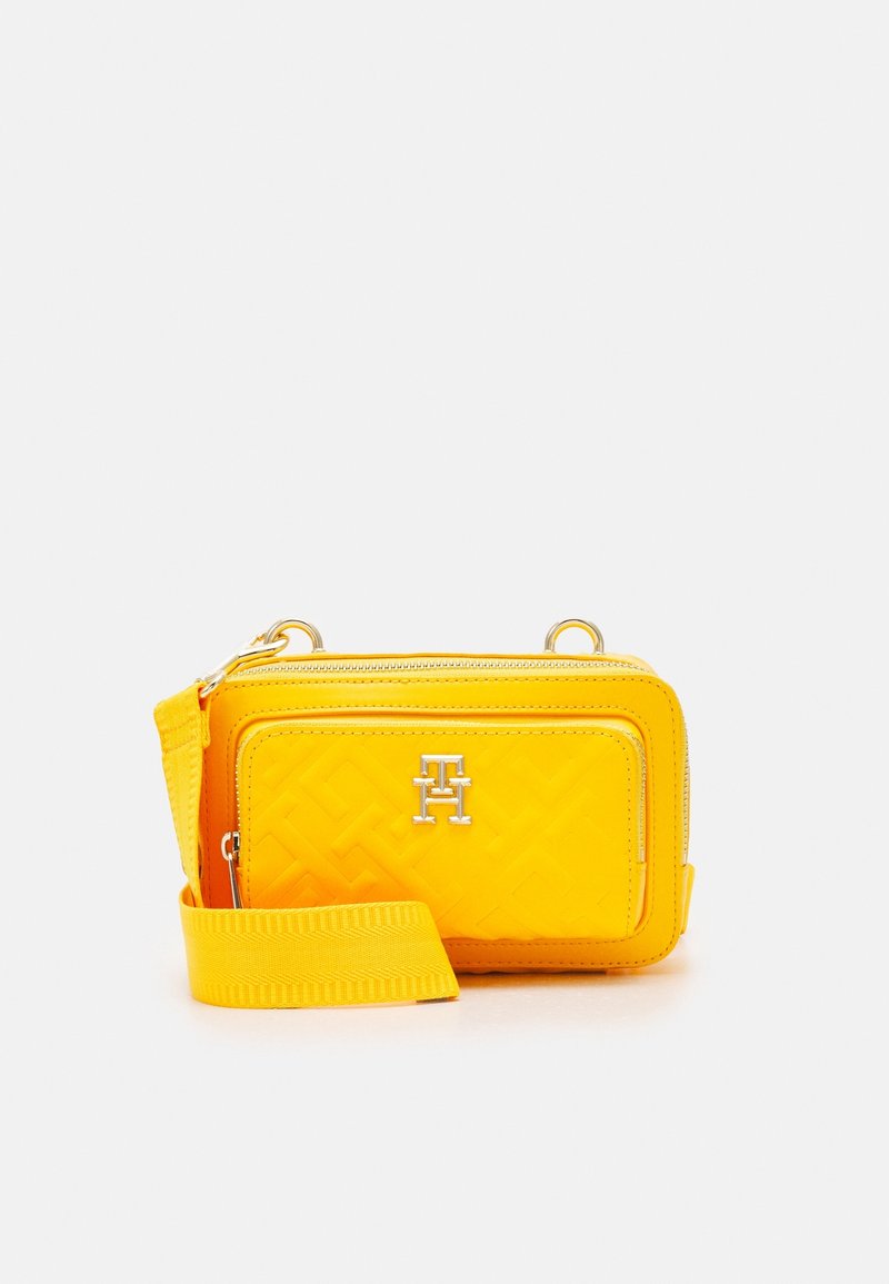 Yellow synthetic crossbody bag with a textured surface, silver hardware, zippered compartments, and an adjustable strap.