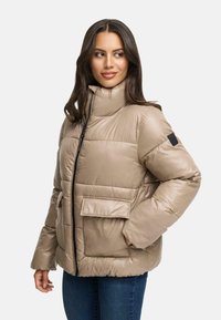 Puffer jacket in light beige with front zipper, high collar, chest pocket, and side pockets. Smooth, shiny texture.