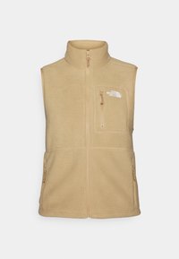 Beige fleece vest met hoge kraag, ritssluiting aan de voorkant en één borstzak. Voorzien van dubbele zijzakken en een gladde textuur.