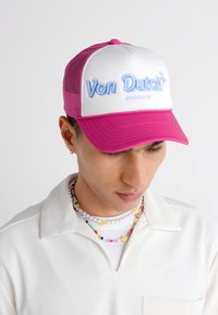 Rosa und weiße Trucker-Cap mit erhabenem blauen "Von Dutch"-Logo, mesh Rückenteil und gebogenem Schirm.