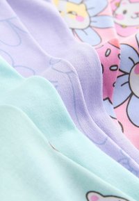 Quatre couches de tissu en coton dans des couleurs pastel : vert menthe, lavande, rose et bleu, avec des motifs ludiques de fleurs et d'animaux.