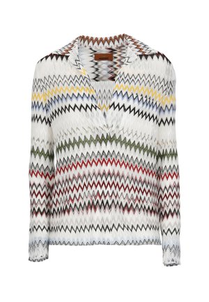 Camicia bianca a maniche lunghe con motivi a zigzag multicolore in giallo, blu, verde, rosso e nero, caratterizzata da scollo a V e colletto.