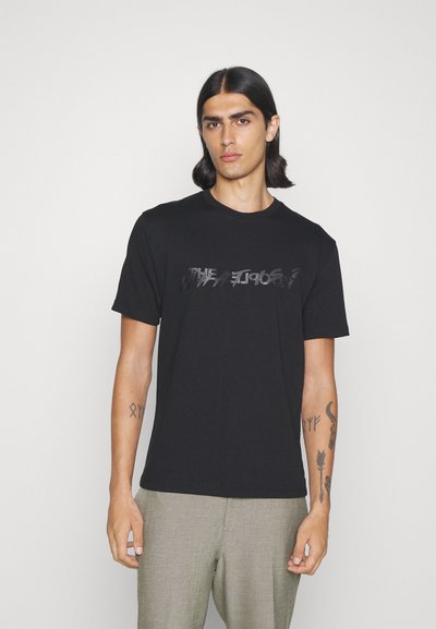 Black cotton t-shirt with short sleeves and a round neck. Features a partially reflective graphic print on the front. Smooth texture.