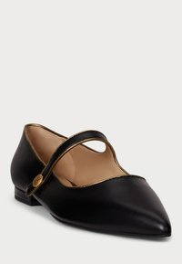 Black leather flats with a pointed toe, gold trim along the edges, and a decorative strap across the instep, featuring a small emblem.