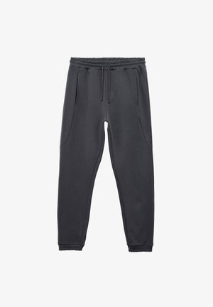 Pantalons jogger gris foncé avec taille élastique, cordon de serrage, deux poches latérales et finitions côtelées aux chevilles. Texture lisse, design décontracté.