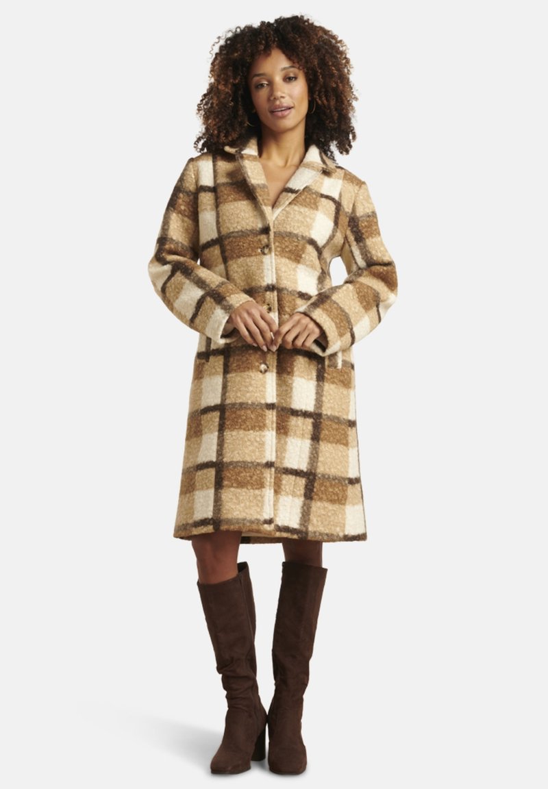 Wool blend coat in a tan and cream plaid pattern, with a notched collar and button front. Features long sleeves and side pockets.