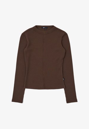 Brown long-sleeve waffle knit top with crew neck, slim fit, and small brand tag on the left side seam.
