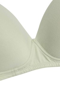 Light green padded bra cups with smooth fabric and visible stitching on the lower band and seams between cups.